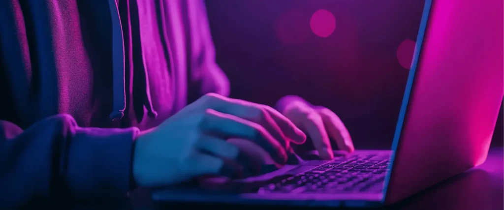 Man performing purple team security assessment on laptop