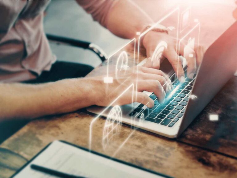 Man performing vulnerability assessment services on laptop