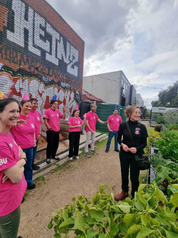 Sentaris team volunteering at food bank outside in garden