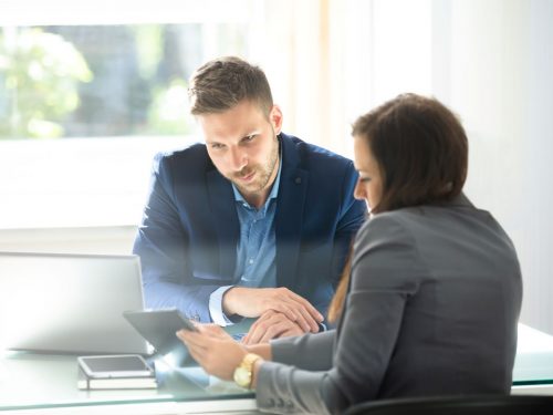 Cyber security consultant providing information to customer at desk
